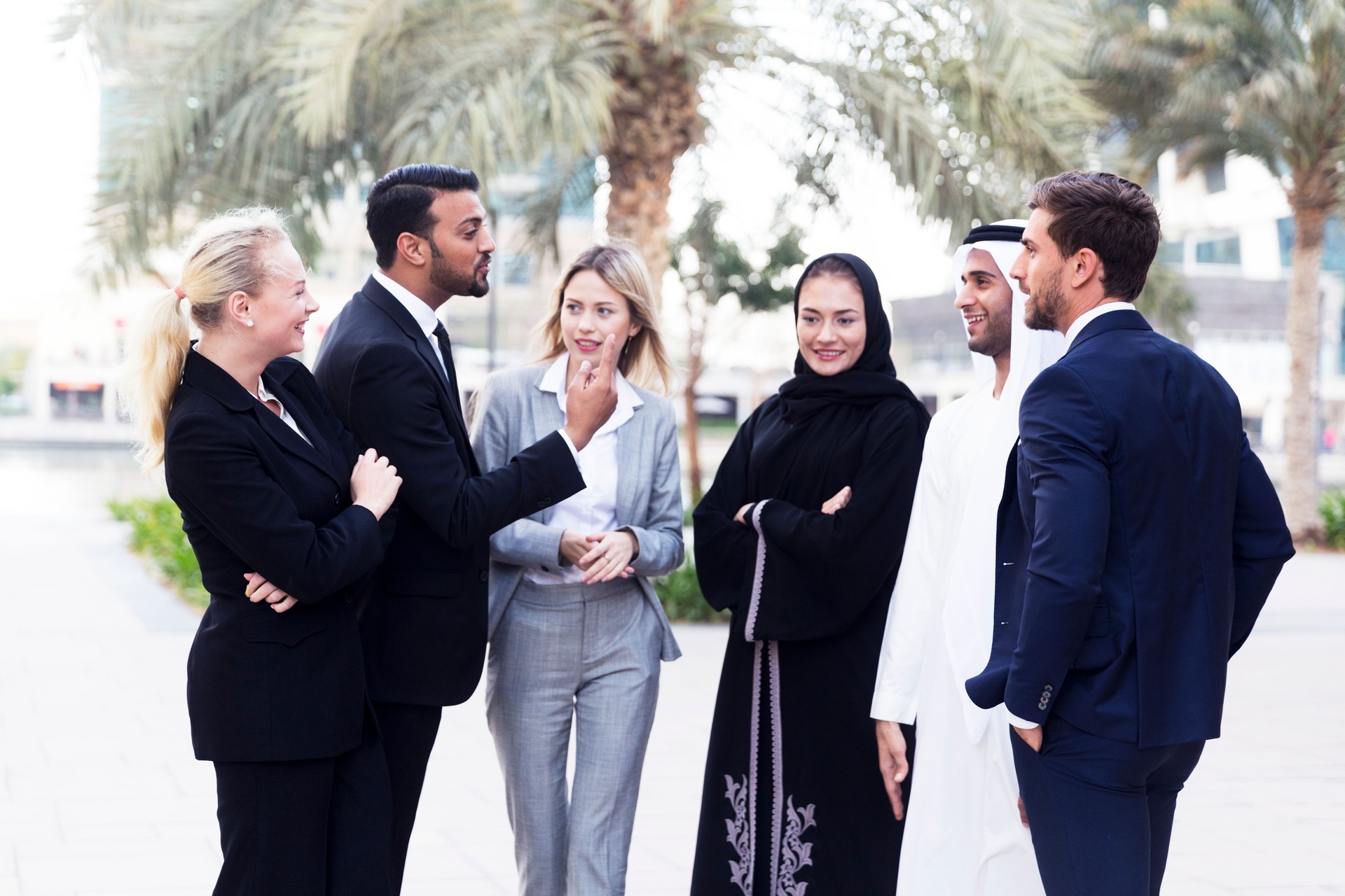 Arab Businessman and woman collaborating with their colleagues after work