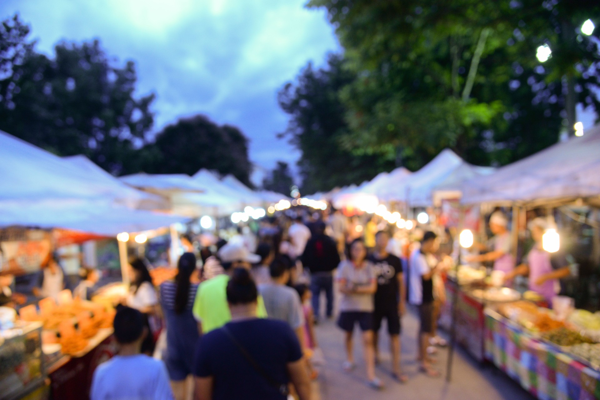 Blurred background of walking street market in bangkok thailand.Tourist walking at local street market for shopping in weekend